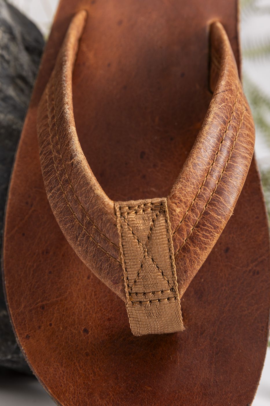 Premium leather sandal strap close-up with triple stitching
